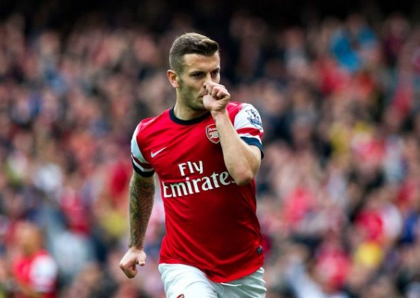 Jack Wilshere scored the opening goal for Arsenal in their 4-1 win over Norwich, keeping them at the top of the Premier League.